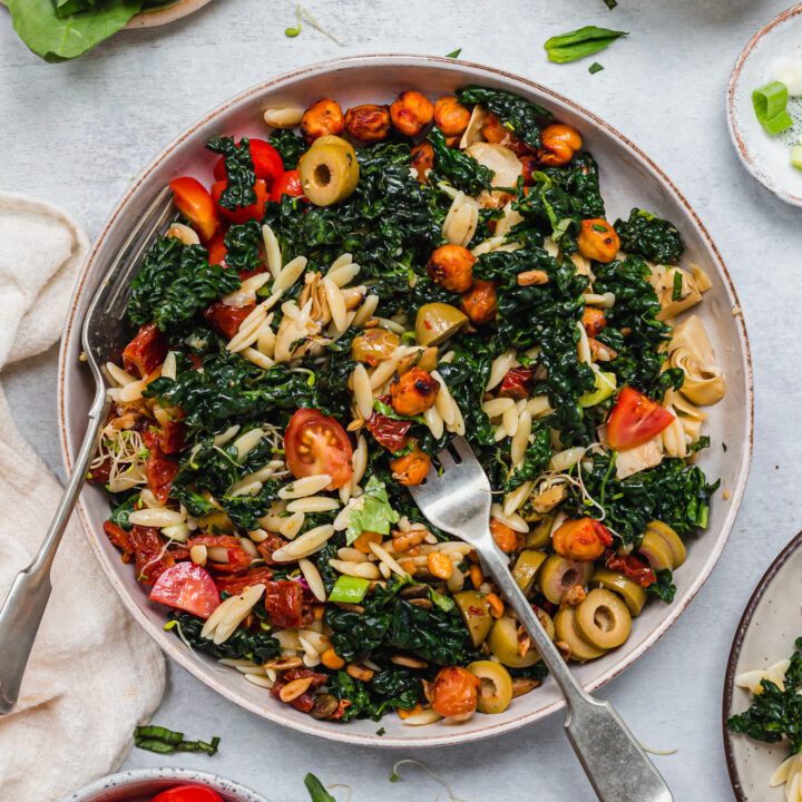 Tossed together Crispy Pesto Chickpea Orzo Salad with two forks