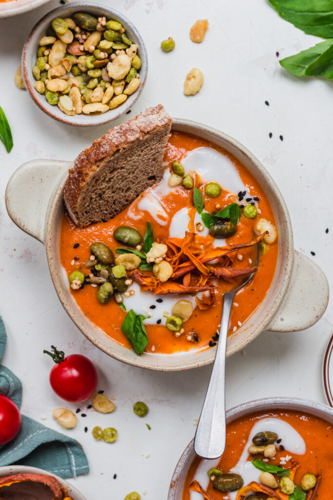 A close up of a bowl of Hidden Vegetable Creamy Tomato Soup with bread