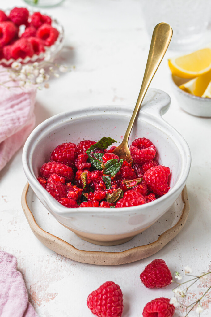 Mashing raspberries into a bowl with a fork