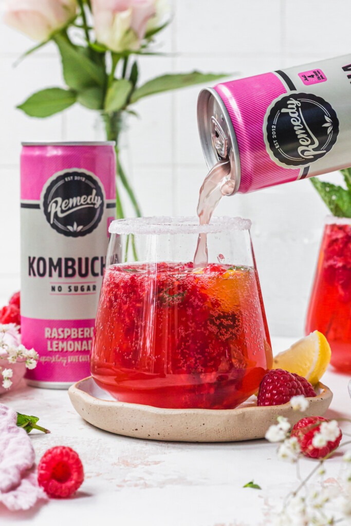 Pouring Remedy Kombucha into a glass of Raspberry Lemon Kombucha Mojito