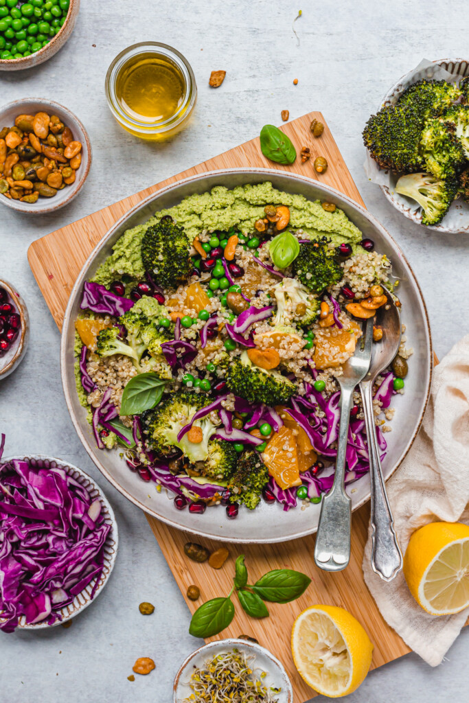 A bowl of Roasted Broccoli Pea and Quinoa on a wooden chopping board