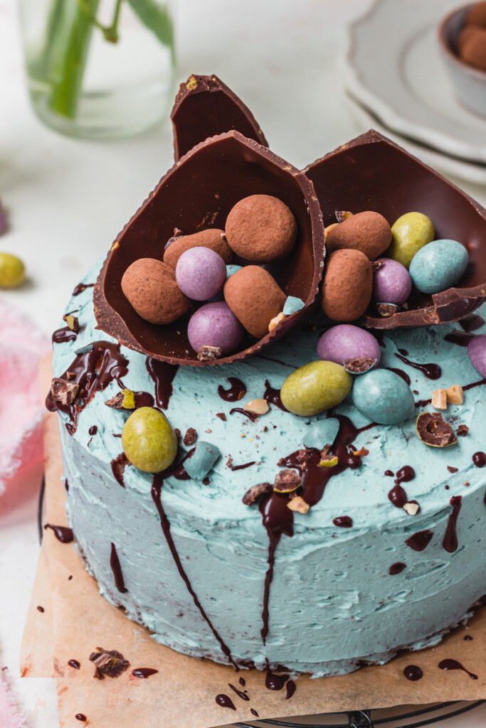Close up of an easter egg shell filled with chocolates and mini eggs