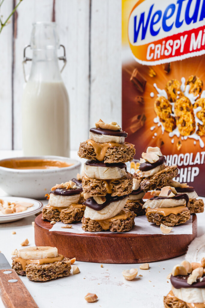 A tower of Chocolate Peanut Butter Banana Weetabix Bites with a box of Weetabix
