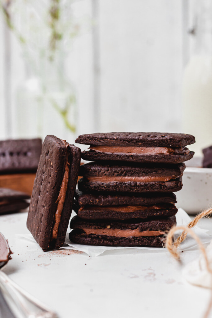 A stack of four Homemade Healthier Vegan Bourbon Biscuits with one leaning up