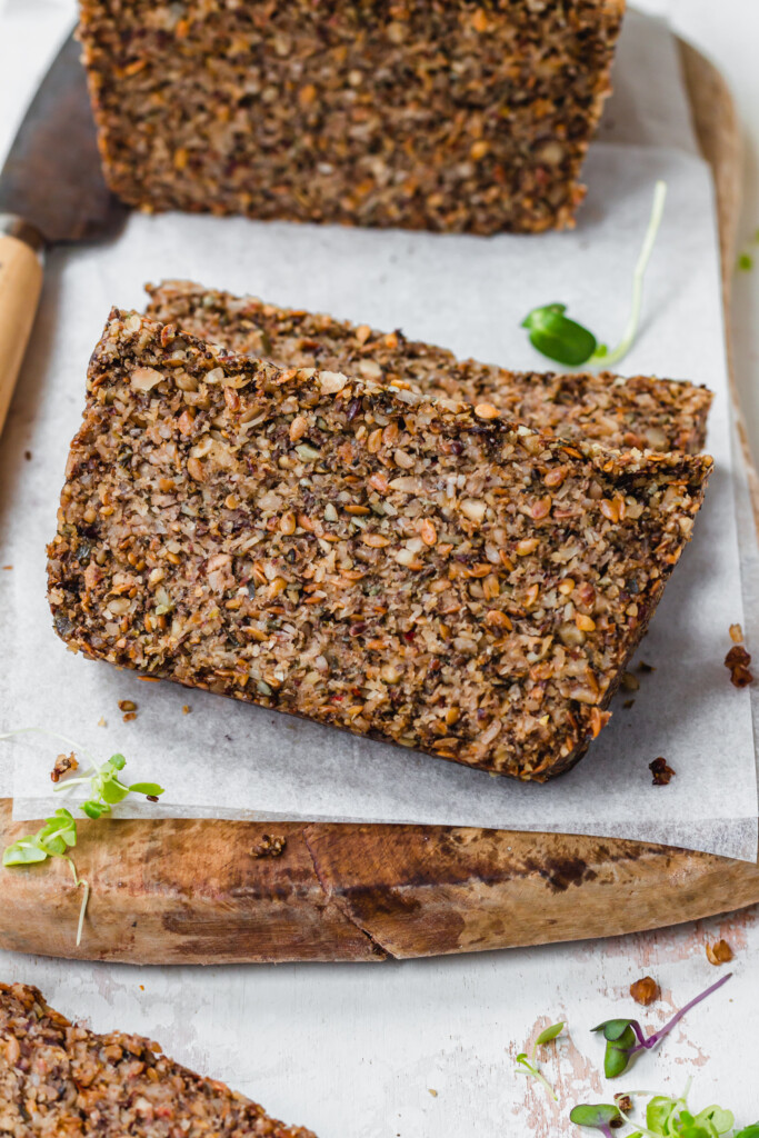 Two slices of Super Seedy Grain-Free Bread on a wooden board