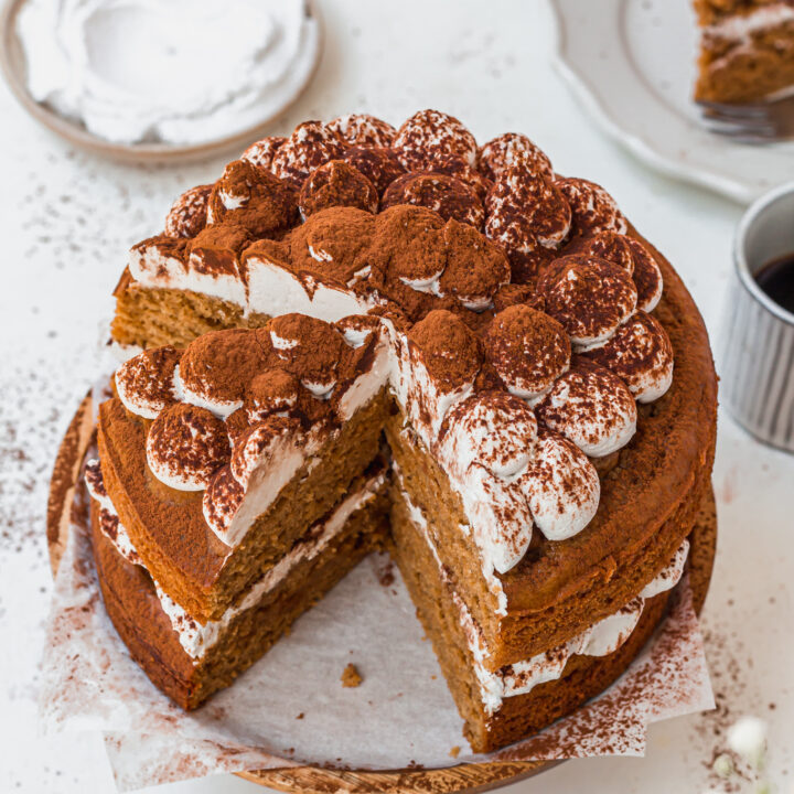 The top of a Vegan Tiramisu Cake with two slices removed