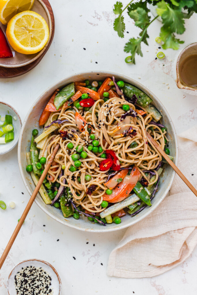 Two chopsticks in a bowl of 10-Minute Tahini Noodle Salad