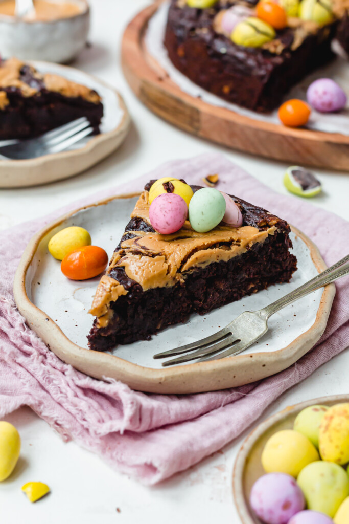 A slice of Mini Egg Peanut Butter Flourless Brownies on a plate with a fork