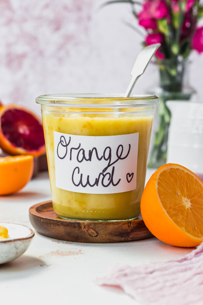 A jar of Vegan Orange Curd with a spoon