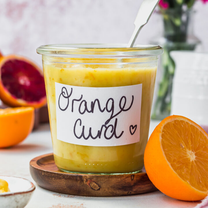 A jar of Vegan Orange Curd with a spoon