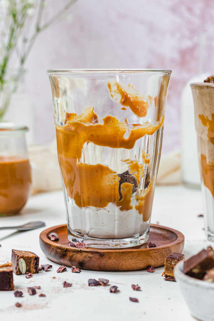 A glass jar with peanut butter and yoghurt
