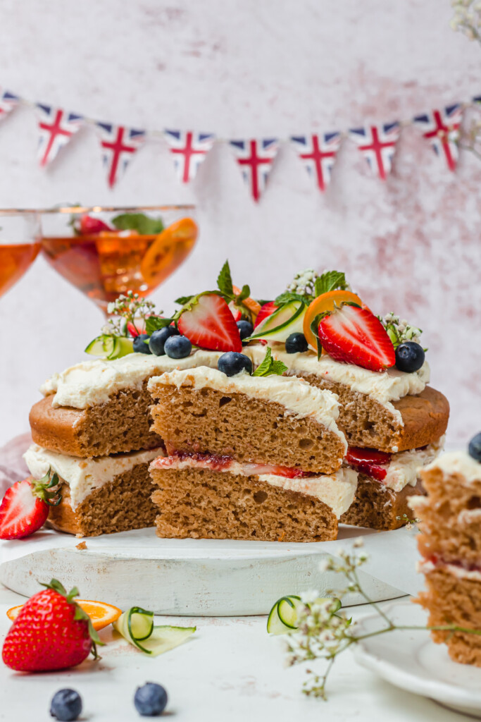 A slice of Vegan Pimm's Cake in front of the cake