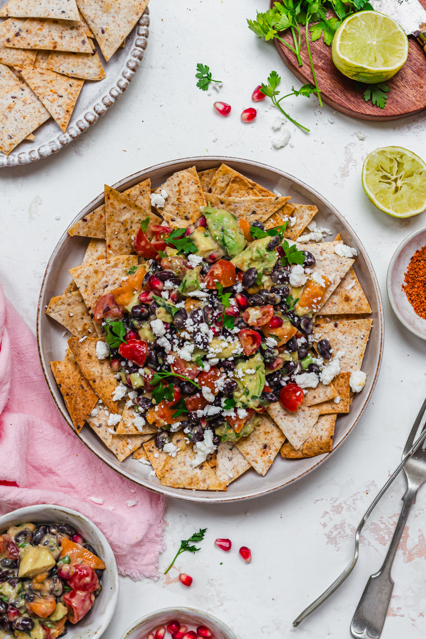 A bowl of tortilla chips topped with black bean salsa with feta cheese