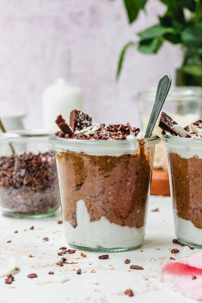 A spoon in a jar of chocolate and coconut oats