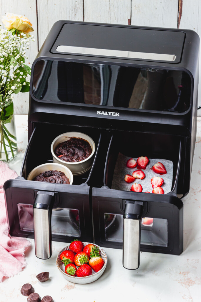 A Salter Air Fryer with one draw containing chocolate cake pots and one with strawberries