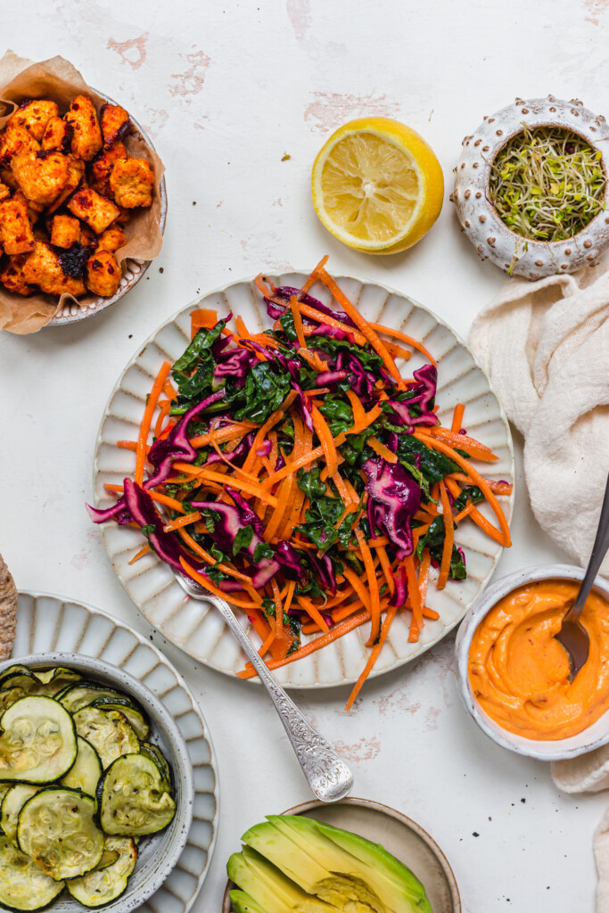 Kale, red cabbage and carrot slaw salad with a fork