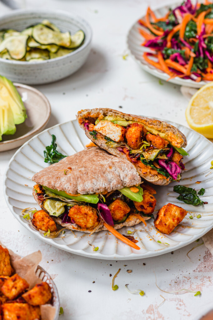 Sliced up pitta bread filled with harissa tofu, courgettes and avocado