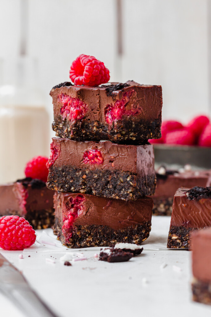 A stack of three No Bake Chocolate Raspberry Ganache Brownies