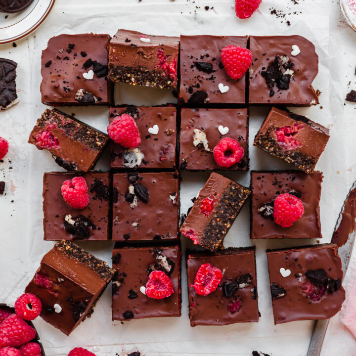 16 squares of No Bake Chocolate Raspberry Ganache Brownies on a white board