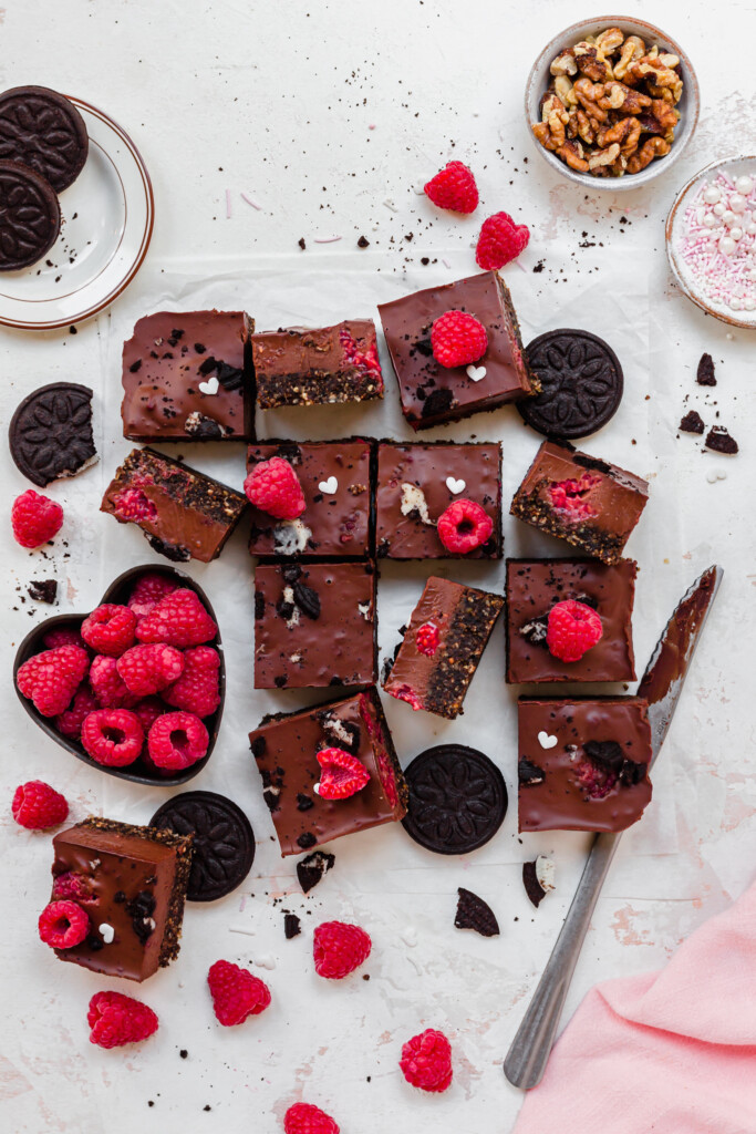 A pile of squares of No Bake Chocolate Raspberry Ganache Brownies with oreo cookies