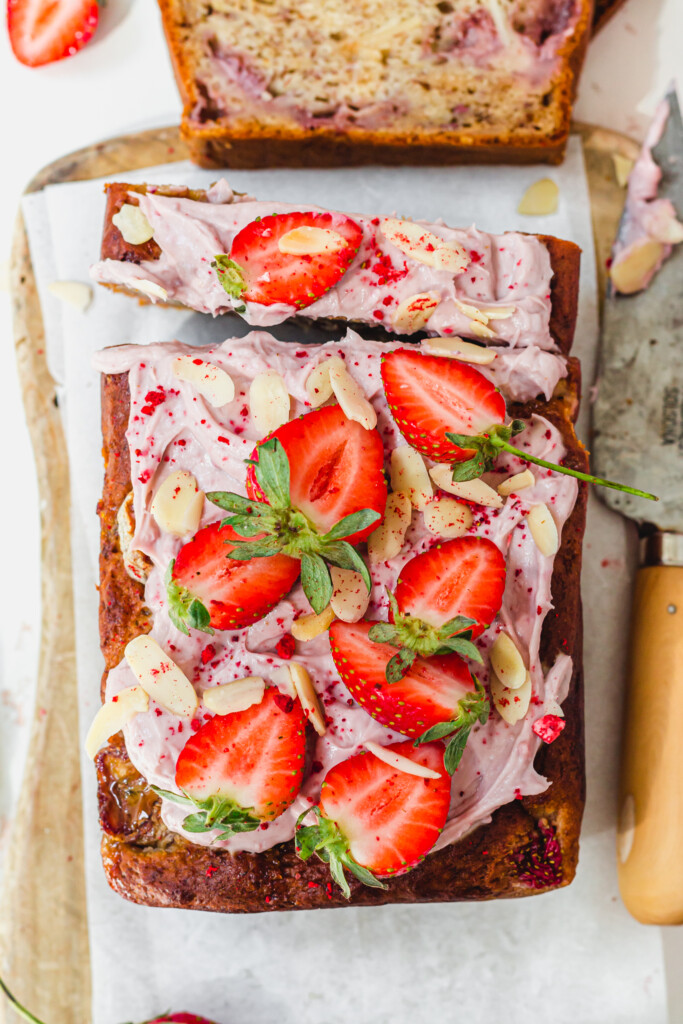 The top of a loaf of Strawberry Almond Banana Bread with strawberries