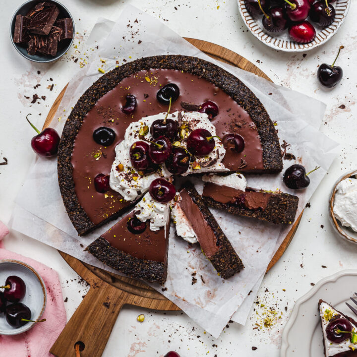 A Black Forest Chocolate Ganache Tart with three slices cut out