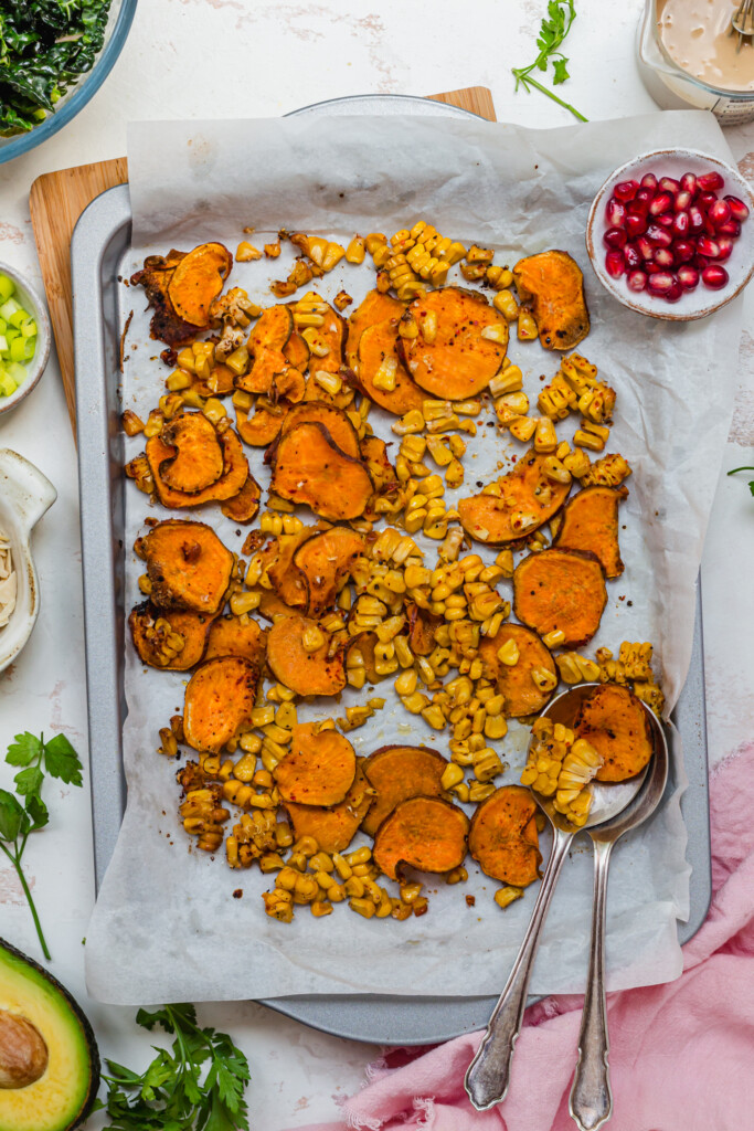 A tray of thinly sliced and roasted sweet potato and charred corn