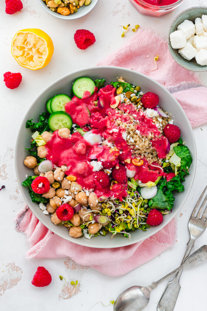 Raspberry dressing drizzled over a chickpea kale salad