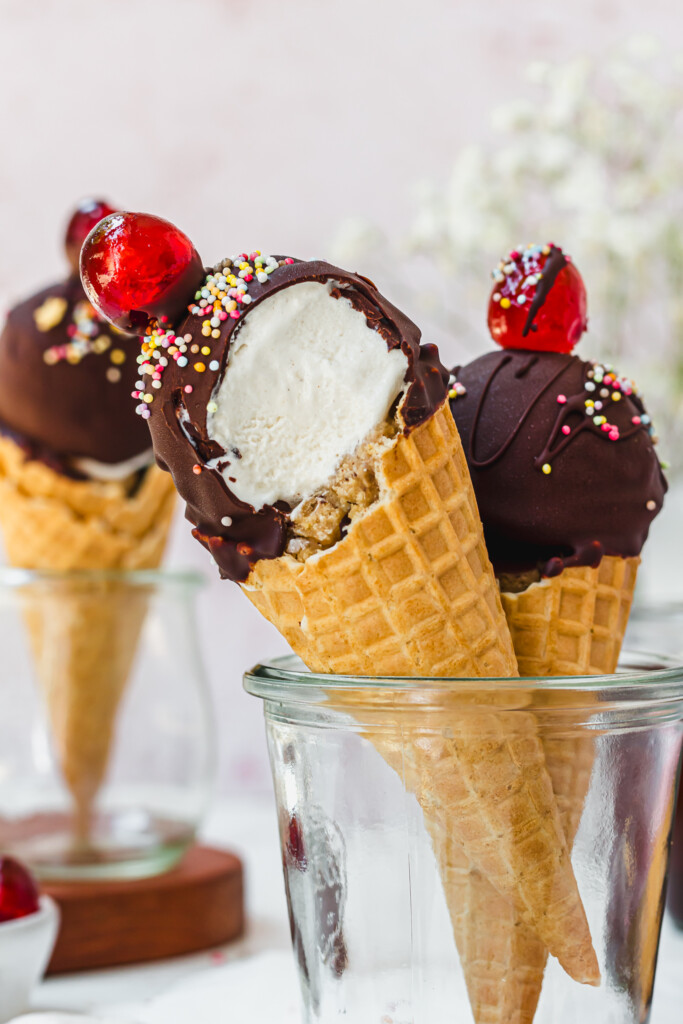 Close up of a wafer cone with ice cream, cookie dough and chocolate