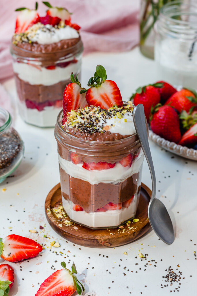 A Chocolate Strawberry Chia Pudding jar with a spoon
