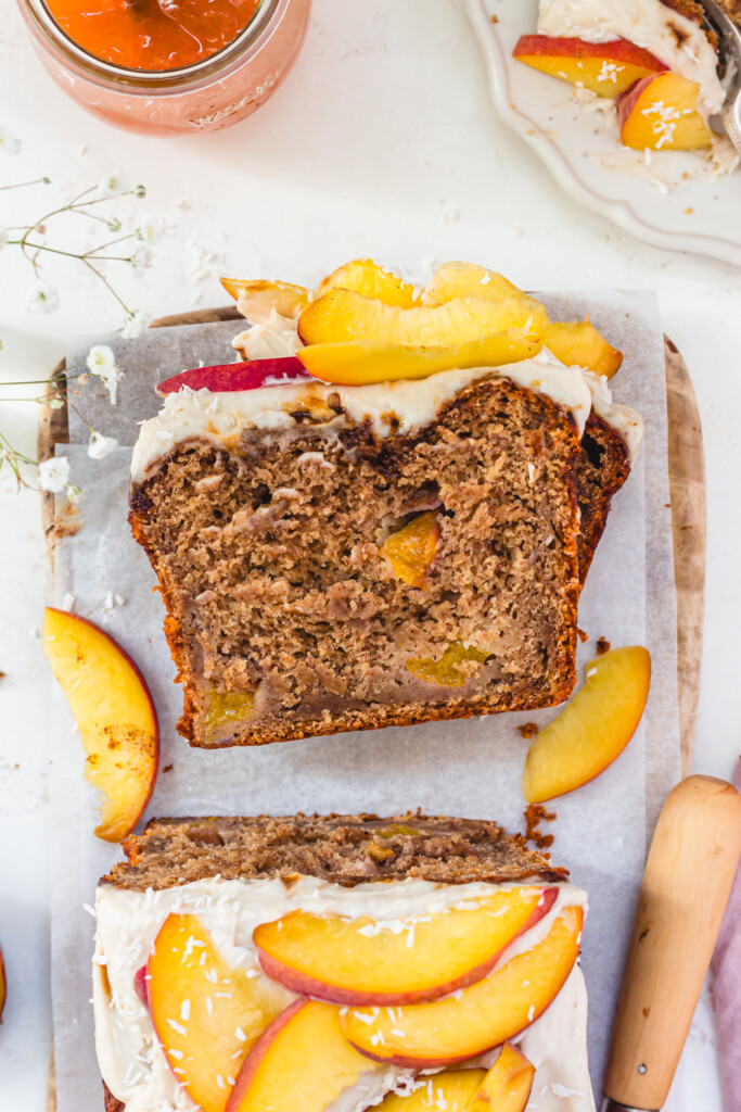 A slice of Peaches and Cream Banana Bread next to the loaf
