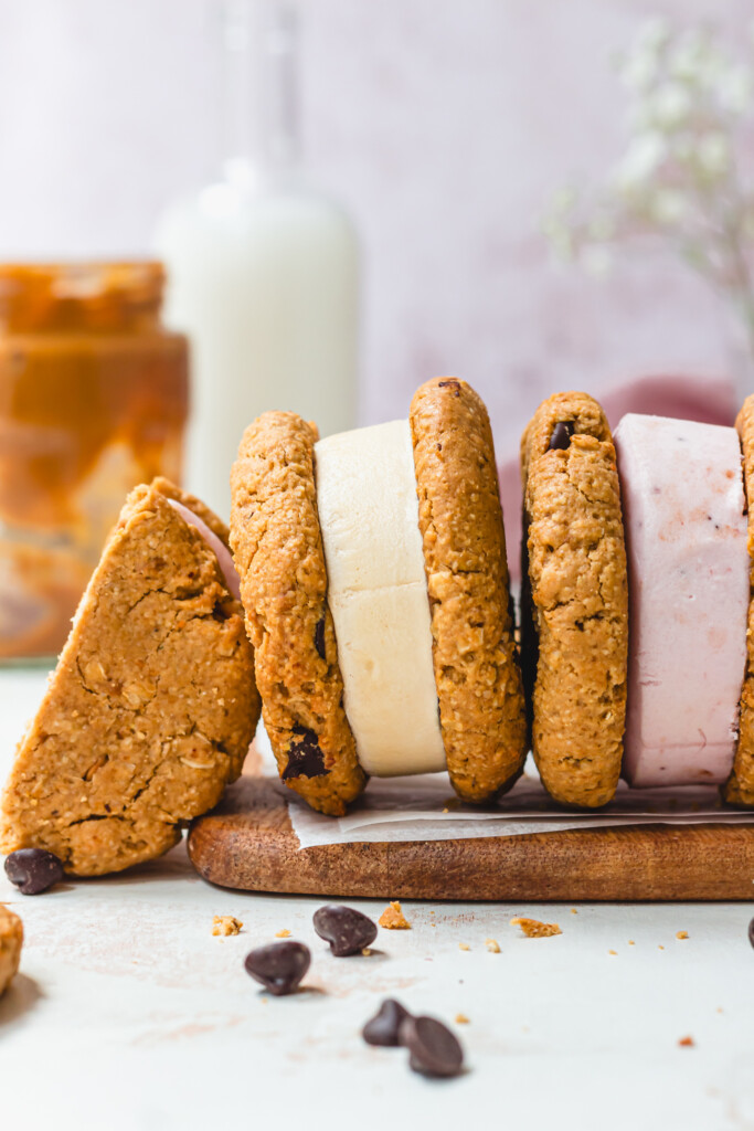 Two and a half Peanut Butter Cookie Ice Cream Sandwiches on a wooden board
