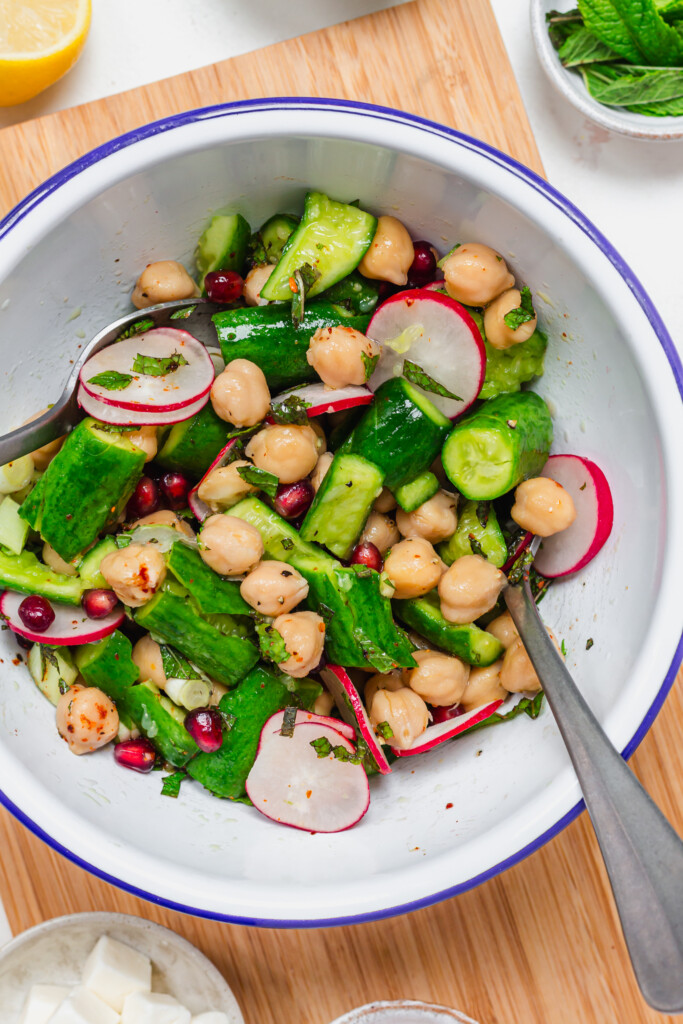 Cucumbers, chickpeas and radishes in a bowl