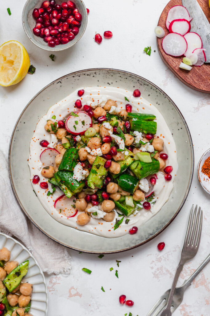 A plate of Smashed Cucumber and Chickpea Salad with two forks