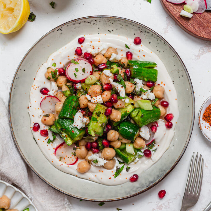 A plate of Smashed Cucumber and Chickpea Salad with two forks