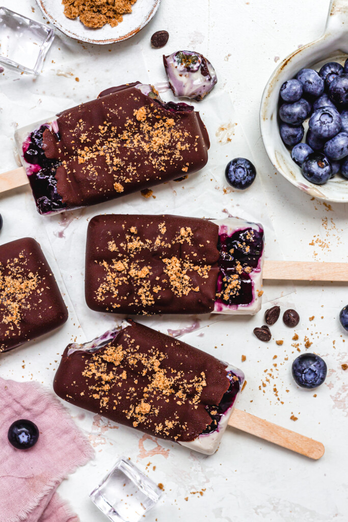 Four Blueberry Cheesecake Magnum Ice Creams with lolly sticks