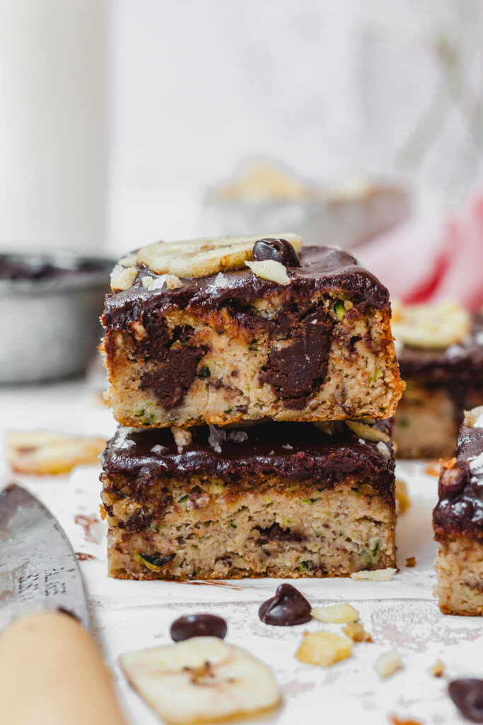 A stack of five Chocolate Chip Banana Zucchini Bars with one bitten