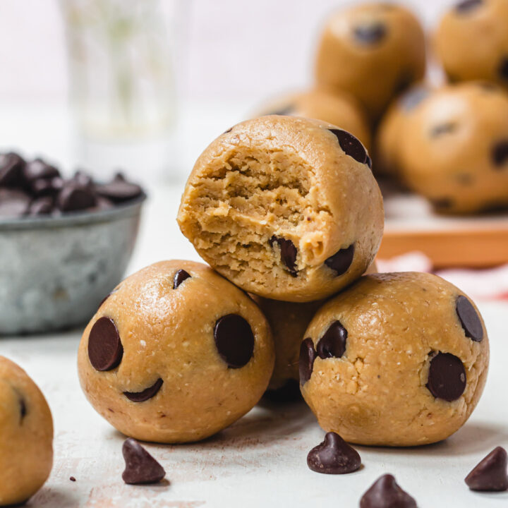 Three Healthy Chocolate Chip Cookie Dough Balls with one bitten