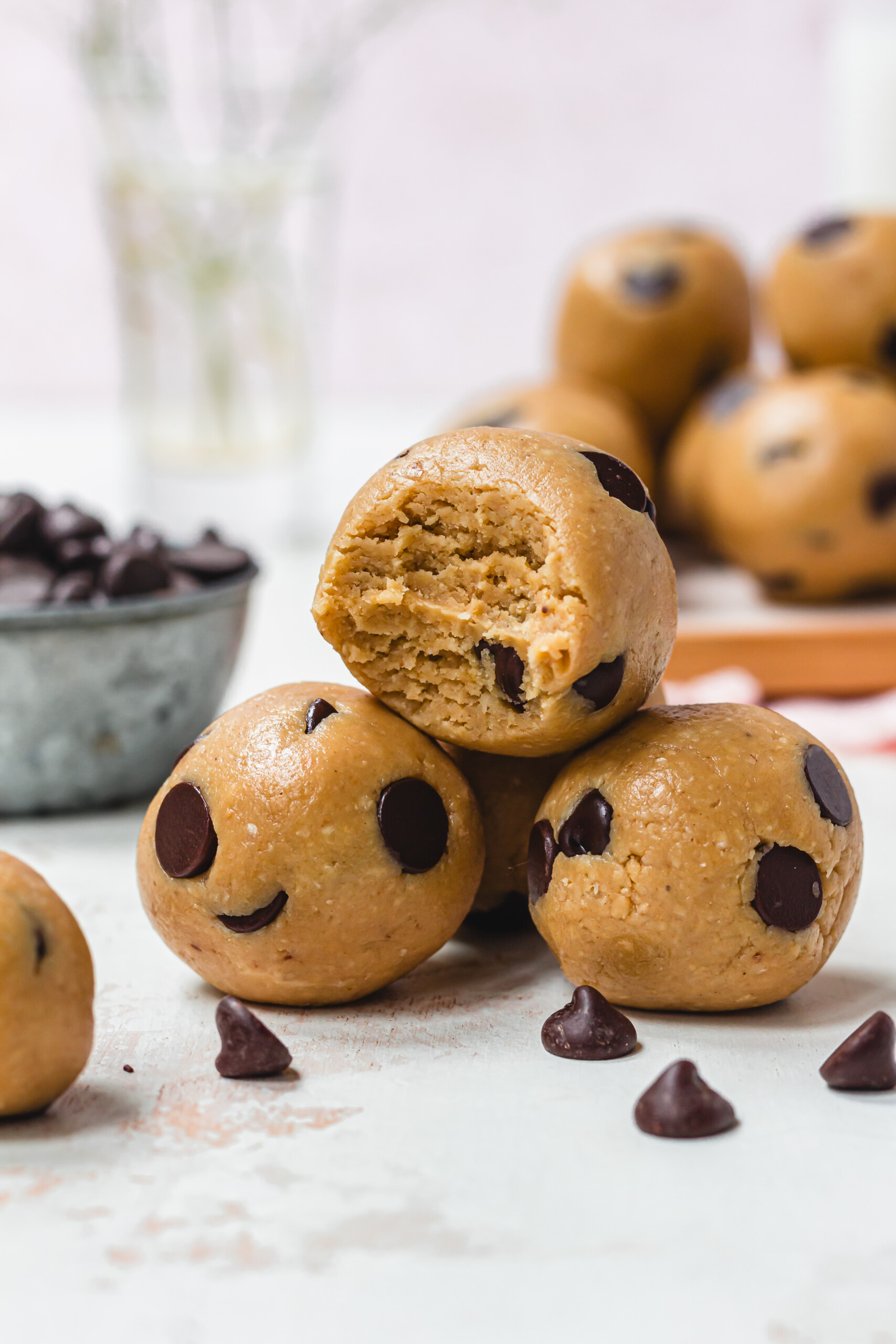 Three Healthy Chocolate Chip Cookie Dough Balls with one bitten