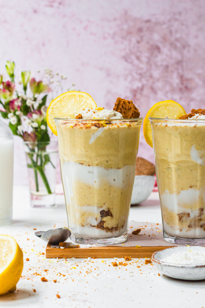 Two glasses of Lemon Meringue Smoothie with lemon slices and cookies