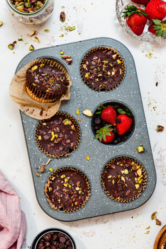A muffin tray with 6 Strawberry Pistachio Ganache Cups