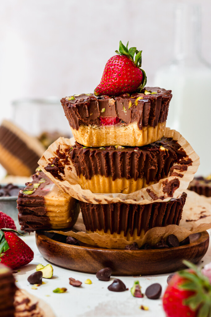 Four Strawberry Pistachio Ganache Cups on a wooden tray