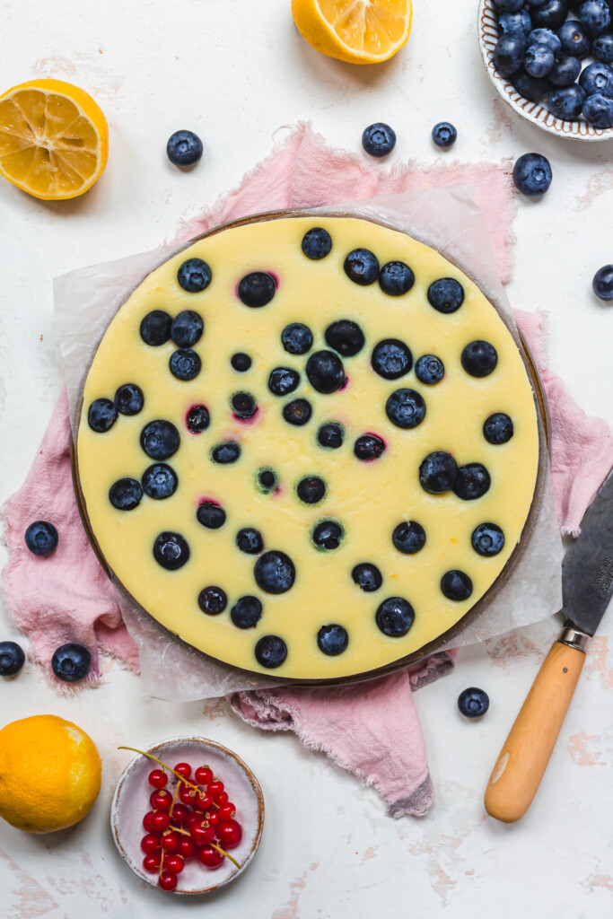 A Vegan Lemon and Blueberry Tart with out toppings on a plate