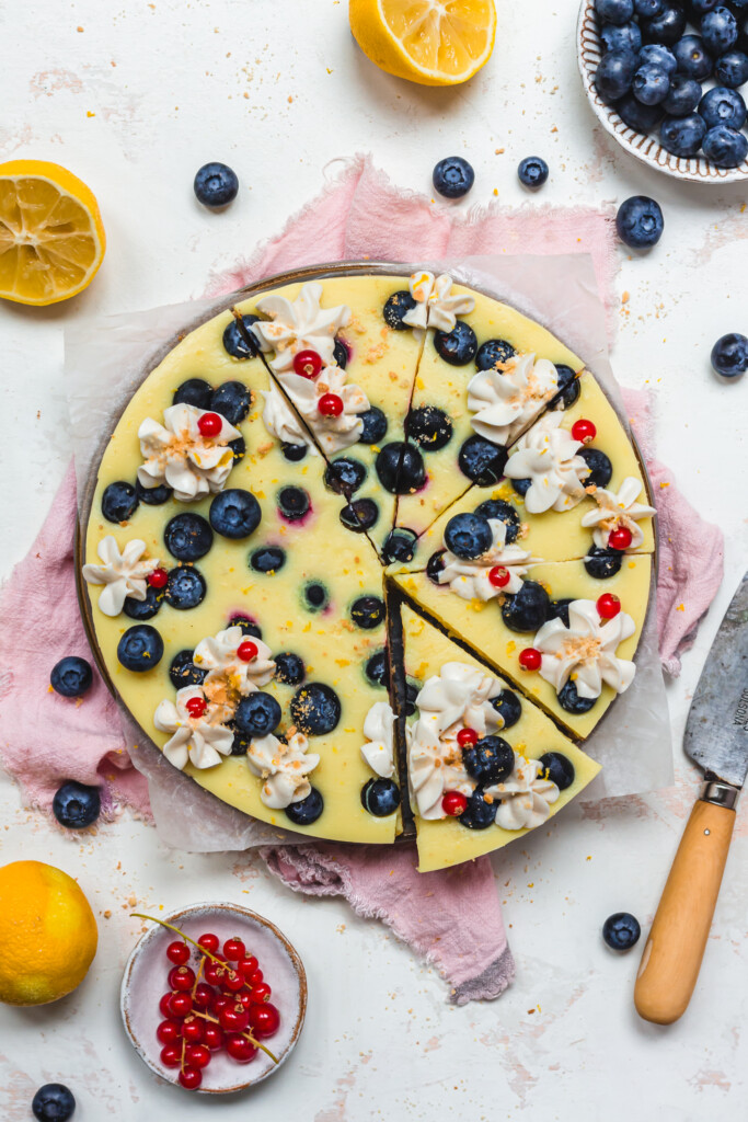 A Vegan Lemon and Blueberry Tart with a knife