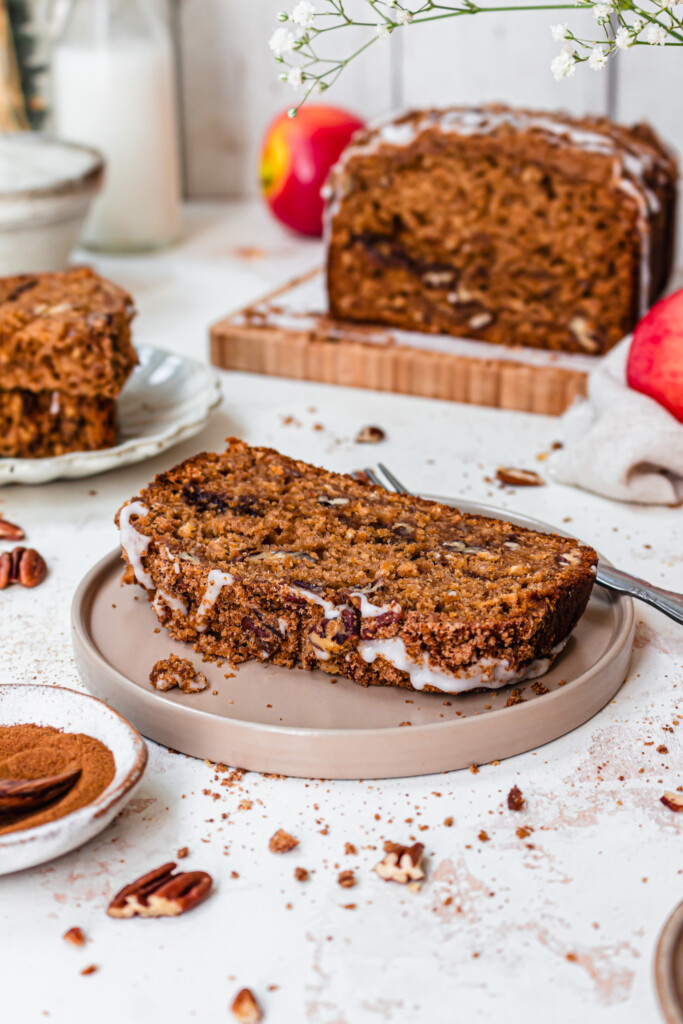 A slice of Apple Pecan Streusel Loaf Cake on a small plate