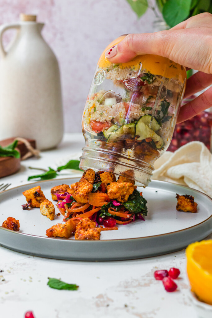 Tipping out a jar of Harissa Tofu Tabouleh Salad onto a plate