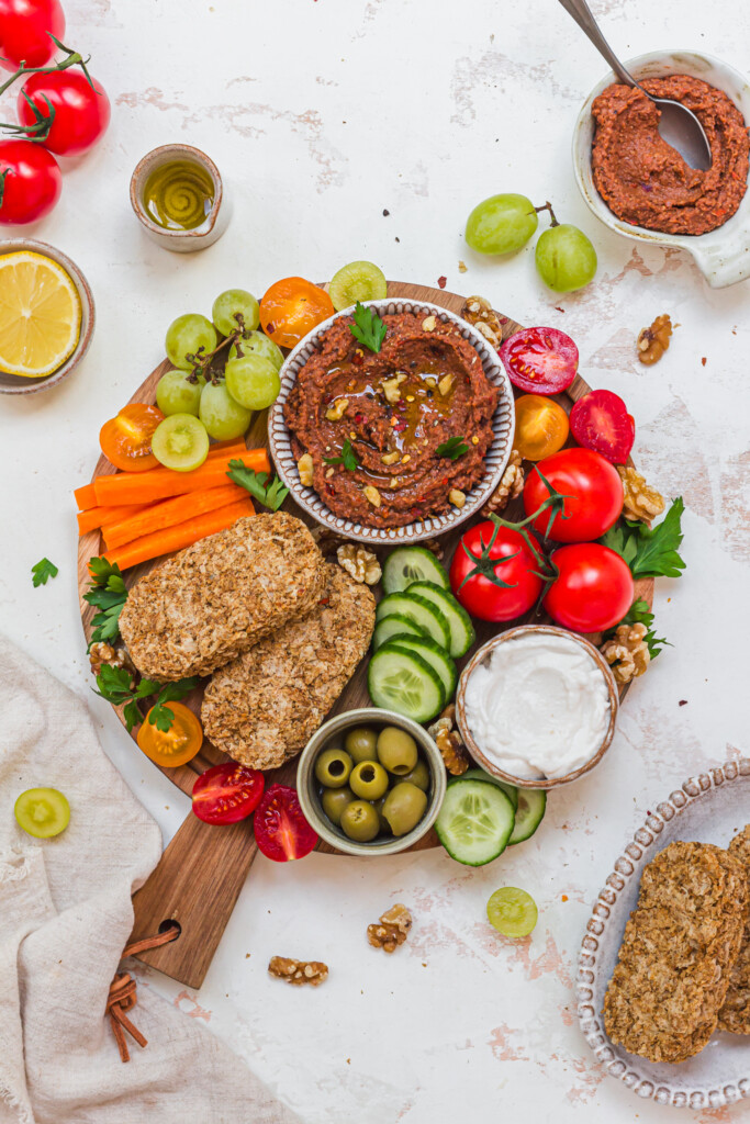 A grazing board with Roasted Red Pepper Butterbean Weetabix Dip and vegetables