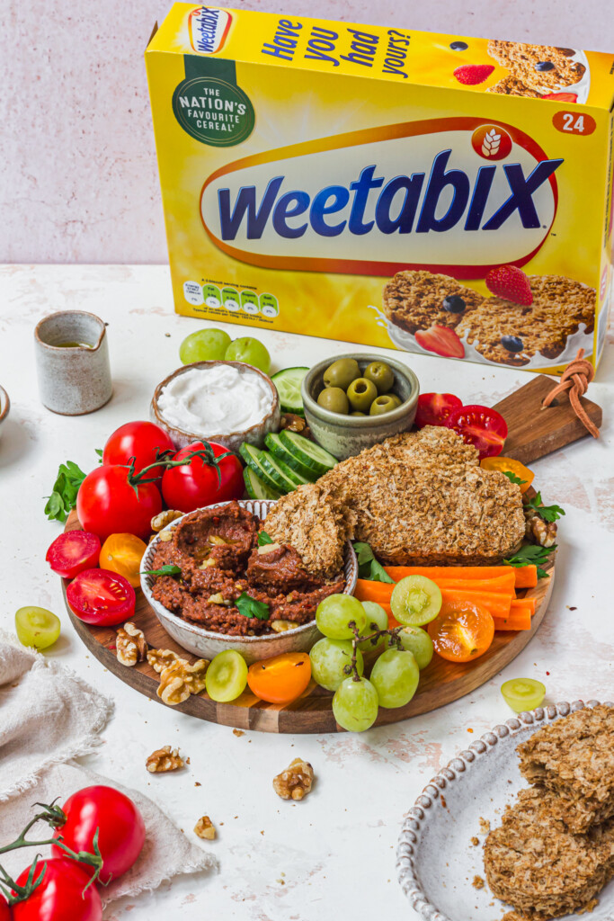 Roasted Red Pepper Butterbean Weetabix Dip on a board with a box of Weetabix