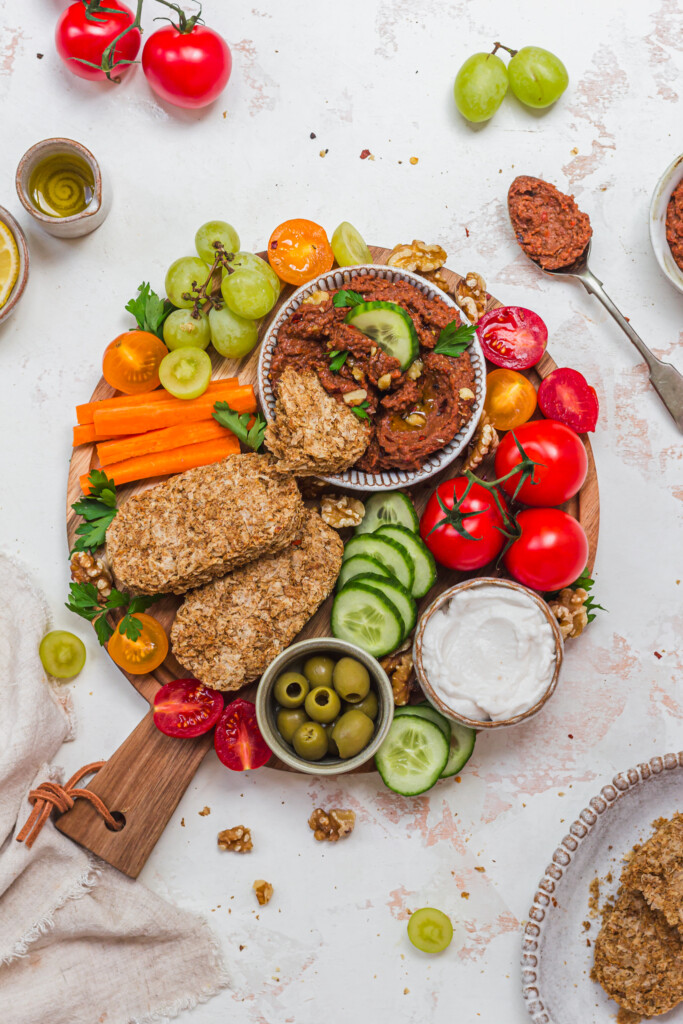 A snacking board with vegetables and Roasted Red Pepper Butterbean Weetabix Dip