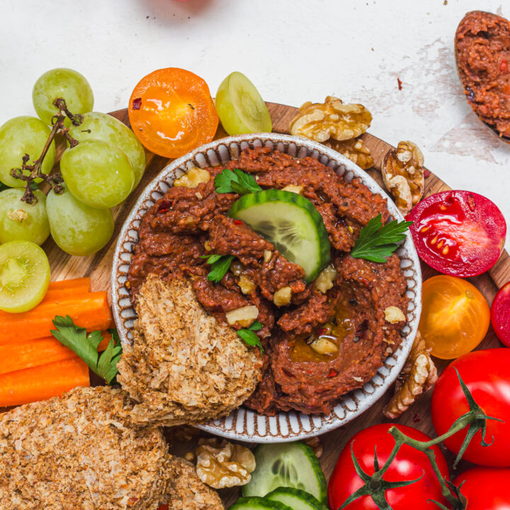 A bowl of Roasted Red Pepper Butterbean Weetabix Dip with cucumber